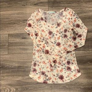 Long sleeve floral pattern shirt.